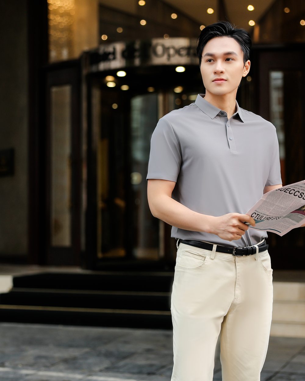 Nam giới mặc áo polo TIKIHITA màu Xám Chì trước sảnh khách sạn